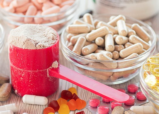 Image of Mineral vitamin pills, powder, gummies on wooden background