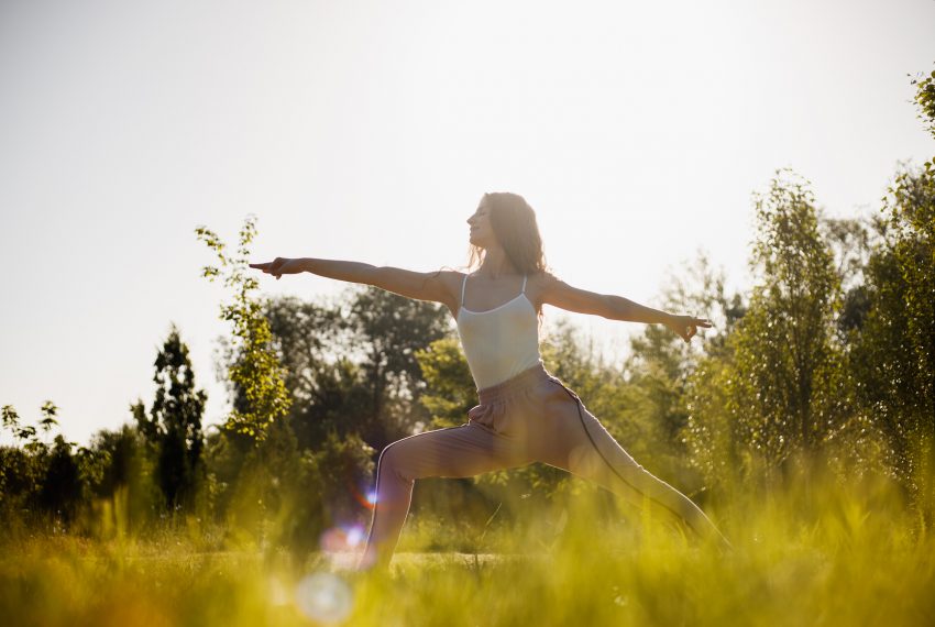 woman yoga in field