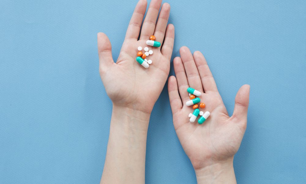 woman taking colorful supplements to treat illness,