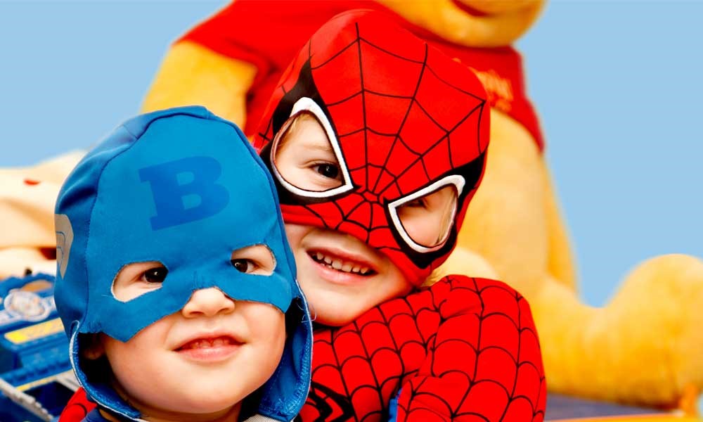 Kids in superhero costumes