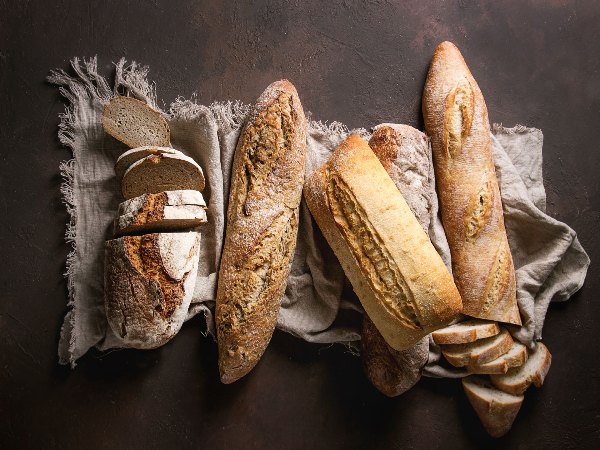 Image of artisan bread lined up on a blanket