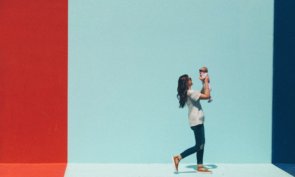 Woman walking and holding a baby