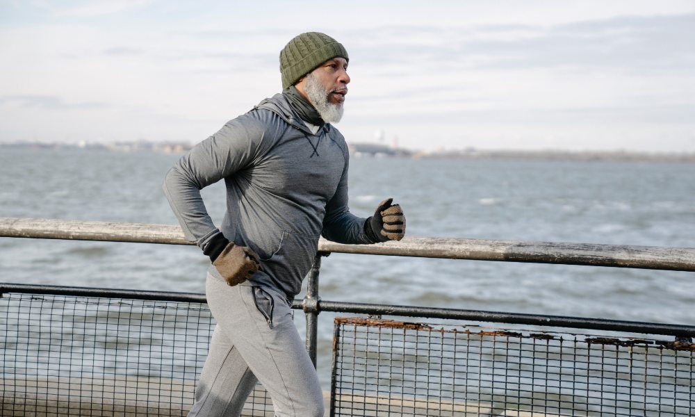 Man jogging next to water