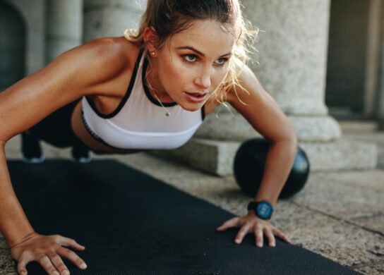 Image of a female athlete doing pushups