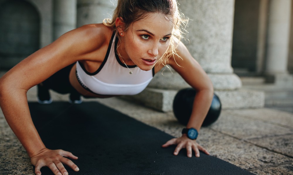 Image of a female athlete doing pushups